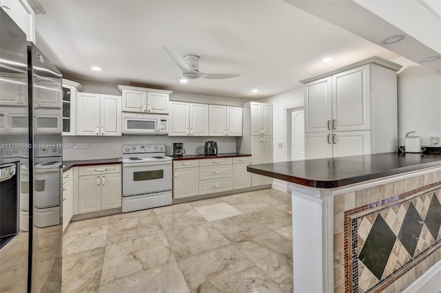814 NE 4th St, Hallandale Beach, FL 33009 - kitchen featuring recessed lighting, white appliances, ceiling fan, and dark countertops