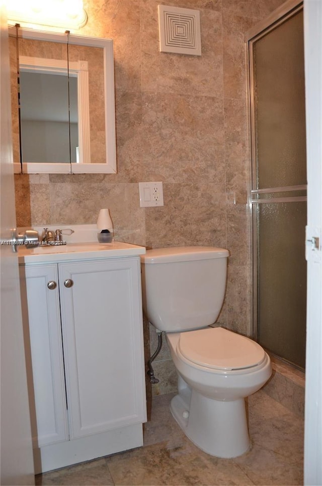 bathroom featuring toilet, a stall shower, visible vents, and tile patterned floors