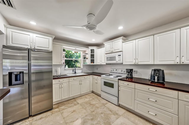 814 NE 4th St, Hallandale Beach, FL 33009 - kitchen with white appliances, a ceiling fan, visible vents, a sink, and dark countertops