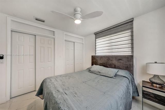 814 NE 4th St, Hallandale Beach, FL 33009 - bedroom with visible vents, marble finish floor, multiple closets, and ceiling fan