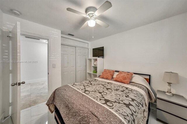 814 NE 4th St, Hallandale Beach, FL 33009 - bedroom with visible vents, a ceiling fan, a closet, and marble finish floor
