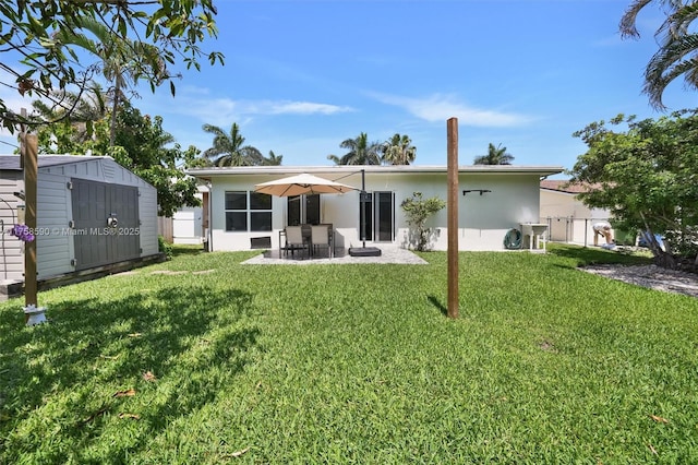 814 NE 4th St, Hallandale Beach, FL 33009 - back of property with a shed, a yard, an outdoor structure, a patio area, and fence