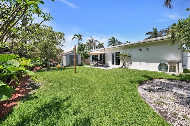 814 NE 4th St, Hallandale Beach, FL 33009 - view of yard featuring a patio area, a storage shed, and an outdoor structure