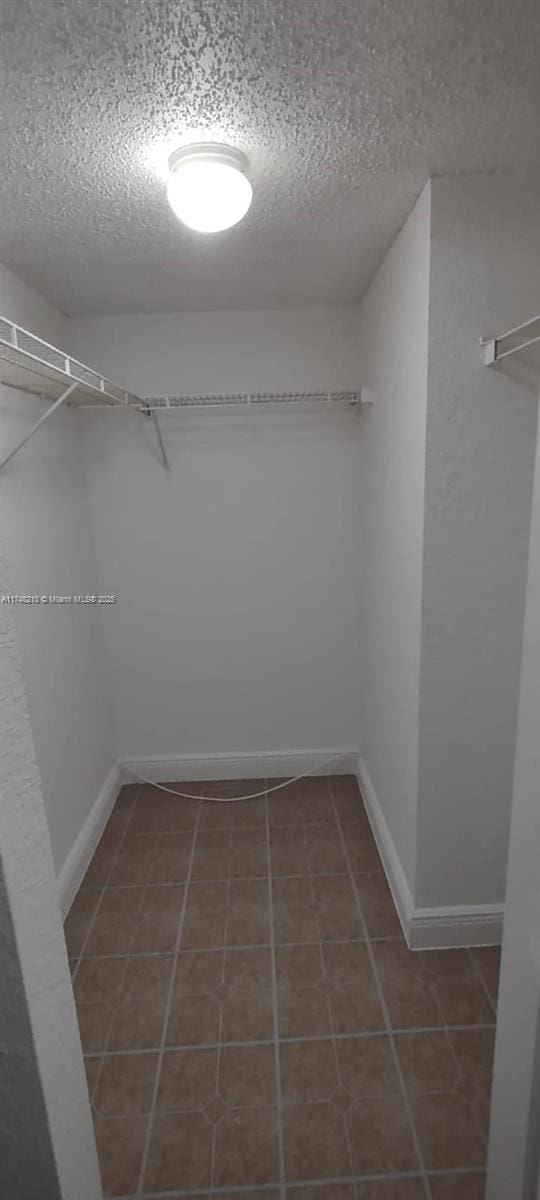 spacious closet featuring tile patterned floors