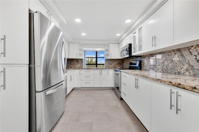 kitchen featuring tasteful backsplash, appliances with stainless steel finishes, light stone countertops, white cabinetry, and open shelves