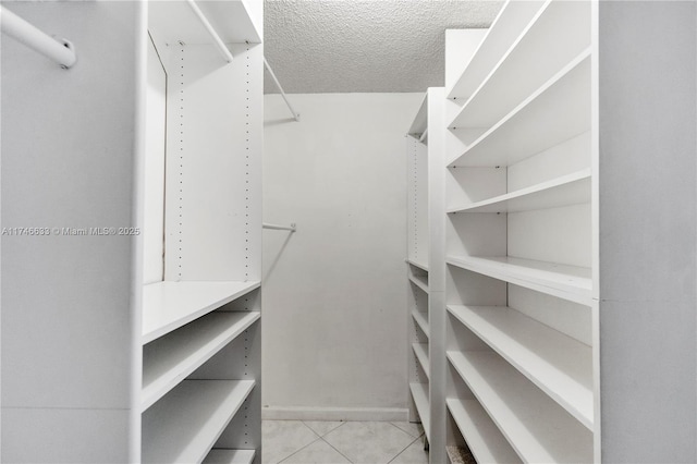 spacious closet with tile patterned floors