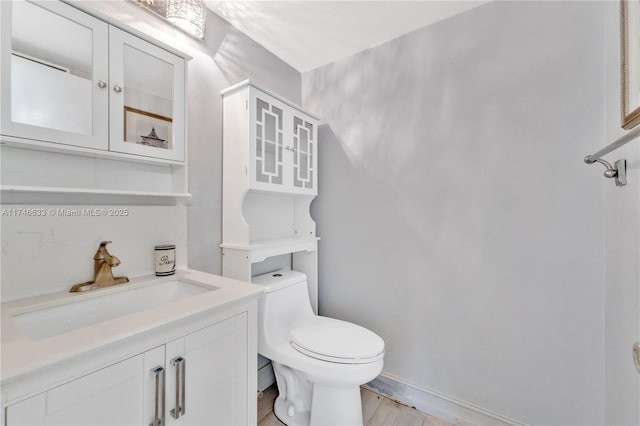 half bathroom with toilet and vanity