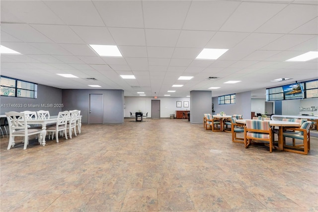 dining space with a drop ceiling