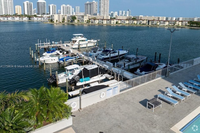 property view of water with a dock and a city view