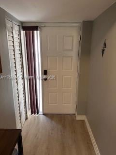 interior space with wood finished floors and baseboards