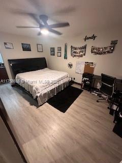 bedroom with a ceiling fan and wood finished floors