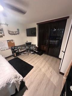 bedroom with wood finished floors and a ceiling fan