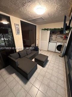 living room with visible vents and independent washer and dryer