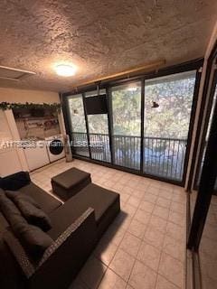 living area with expansive windows and washing machine and clothes dryer