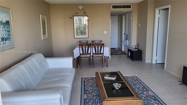 living area with visible vents, baseboards, and light tile patterned flooring