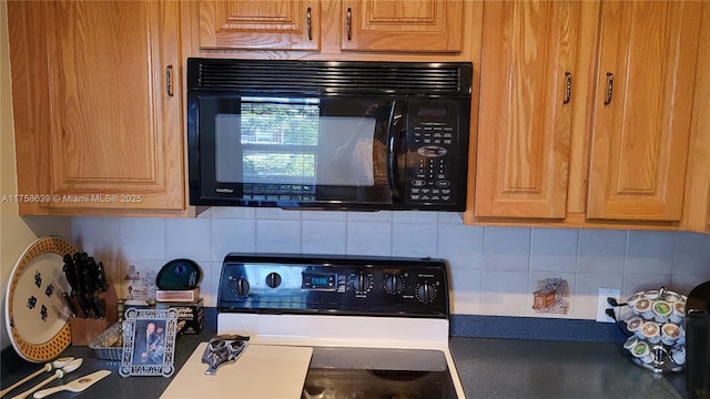 kitchen featuring black microwave, tasteful backsplash, and stove