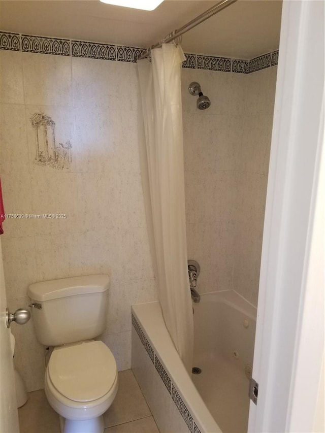 bathroom featuring shower / bath combo, toilet, and tile patterned floors