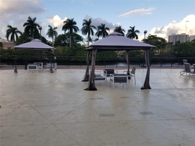 view of home's community with a patio area, fence, and a gazebo