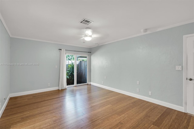 unfurnished room featuring visible vents, crown molding, baseboards, and wood finished floors