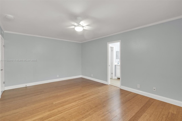 empty room with ceiling fan, baseboards, wood finished floors, and crown molding