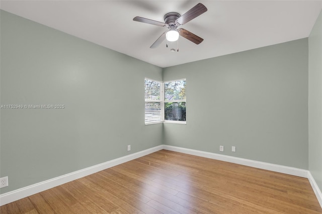 unfurnished room with baseboards, light wood-style flooring, and a ceiling fan