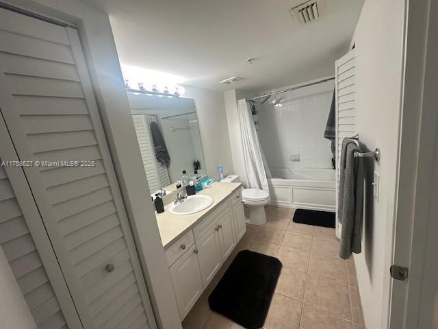 bathroom featuring visible vents, toilet, shower / bath combo, vanity, and tile patterned floors