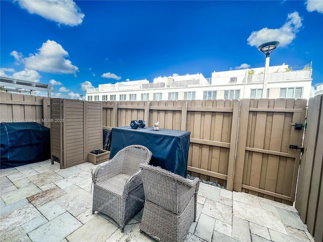 view of patio with fence and grilling area