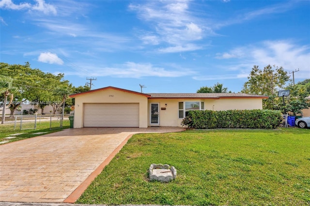 single story home with an attached garage, fence, decorative driveway, stucco siding, and a front lawn