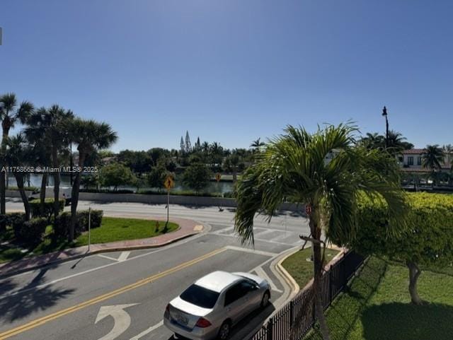 view of road with traffic signs, curbs, and sidewalks