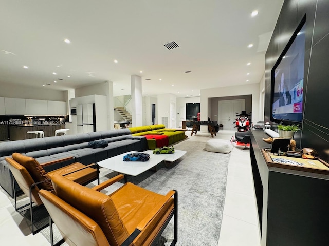 living room featuring stairs, visible vents, and recessed lighting