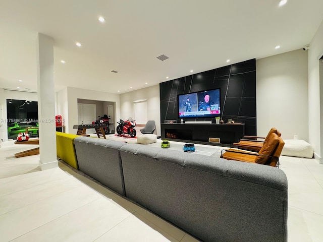 living area with light tile patterned floors, visible vents, and recessed lighting