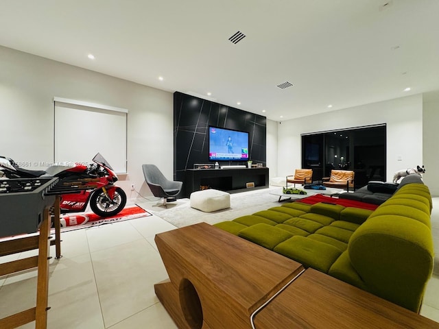 tiled living room featuring visible vents and recessed lighting