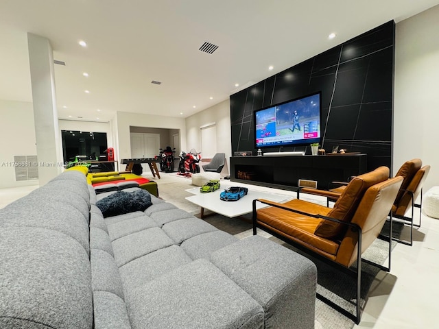 living area featuring recessed lighting and visible vents