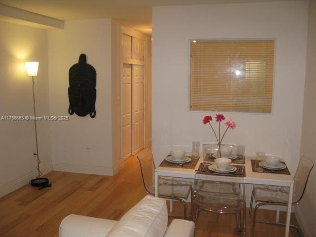 dining area featuring light wood-style floors and baseboards