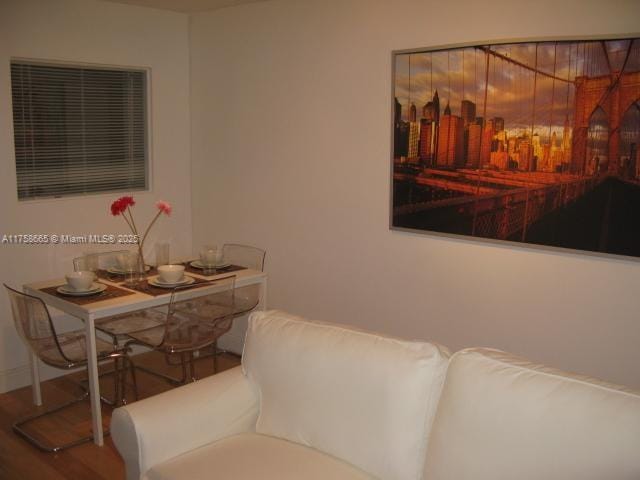 dining space featuring wood finished floors and baseboards