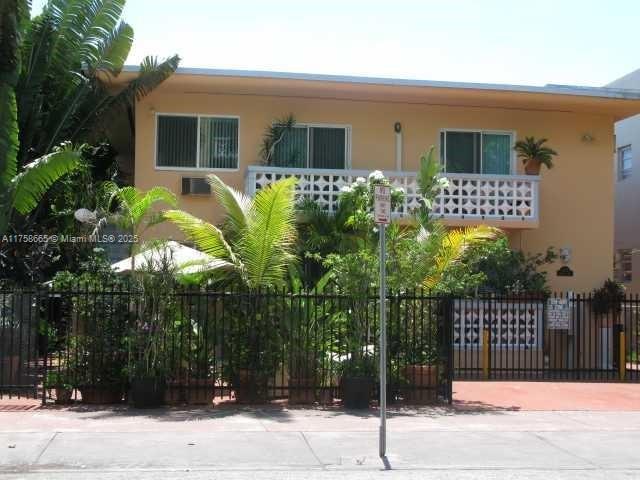 view of front of home with fence and stucco siding