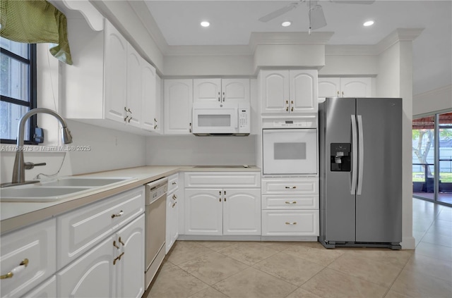 kitchen with recessed lighting, white appliances, a sink, white cabinets, and light countertops