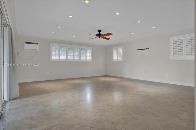 empty room with baseboards, crown molding, and an AC wall unit