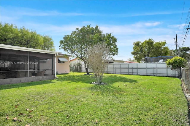 view of yard with a sunroom and a fenced backyard