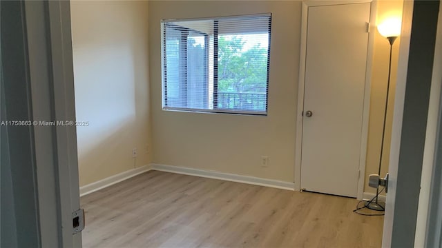 empty room featuring light wood-style flooring and baseboards