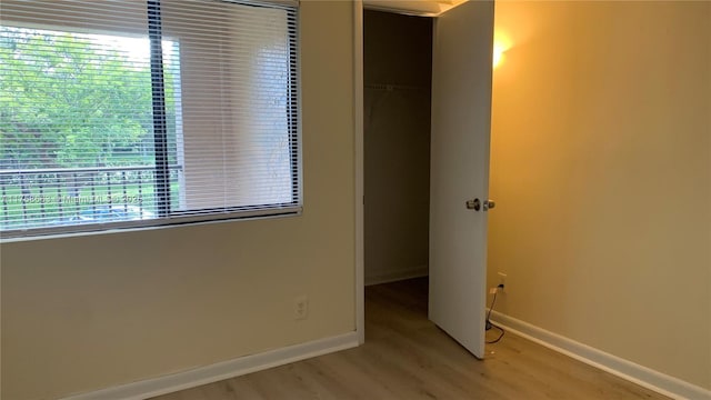 unfurnished bedroom featuring light wood-style floors and baseboards