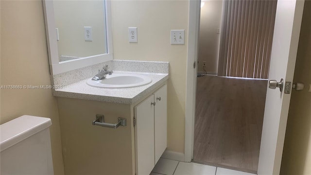 bathroom with vanity, toilet, and tile patterned floors