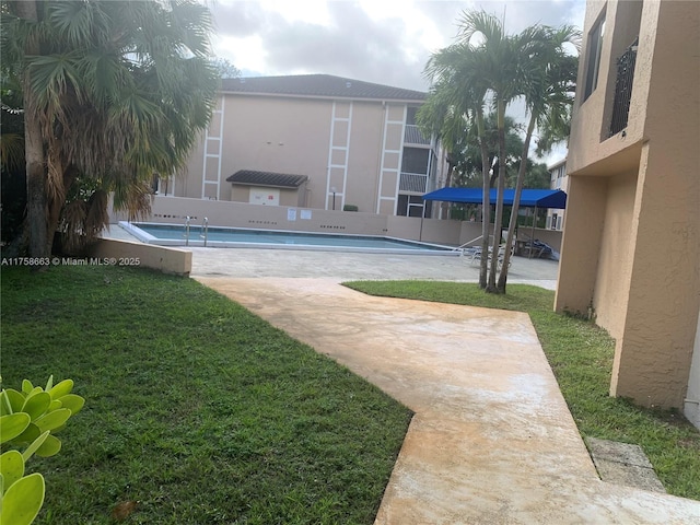 community pool featuring a yard