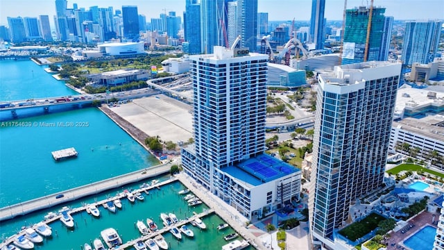 birds eye view of property with a water view and a city view