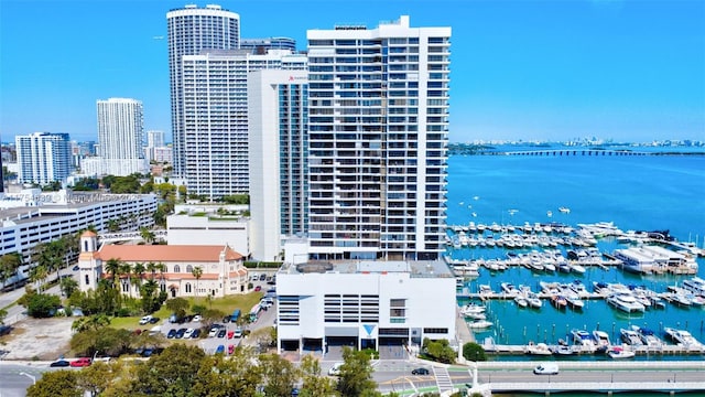 birds eye view of property with a water view and a city view