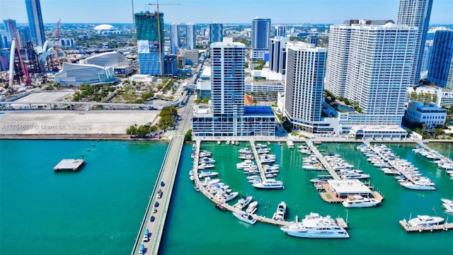 birds eye view of property with a water view and a city view