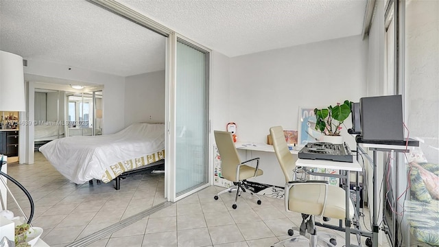 bedroom featuring light tile patterned floors and a textured ceiling