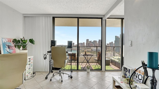 home office with floor to ceiling windows, a textured wall, a textured ceiling, and tile patterned floors