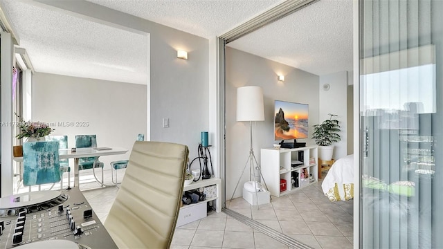 office with light tile patterned floors, plenty of natural light, and a textured ceiling