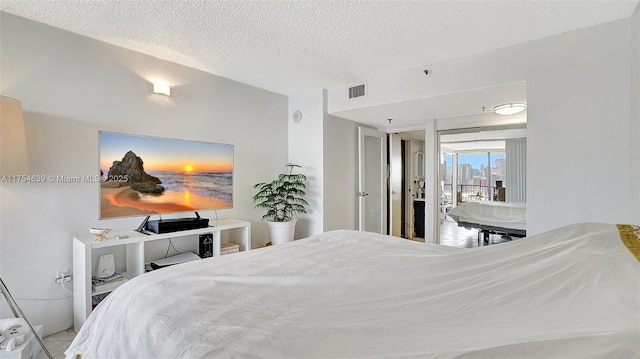 bedroom with visible vents and a textured ceiling